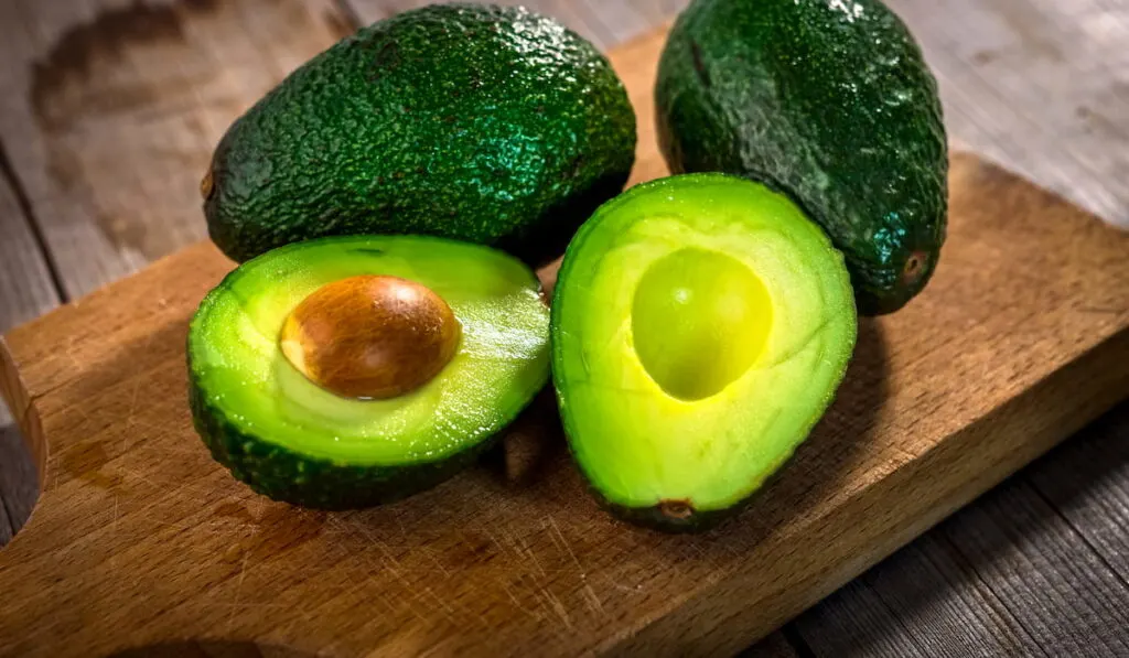 fresh green avocado on the wooden table