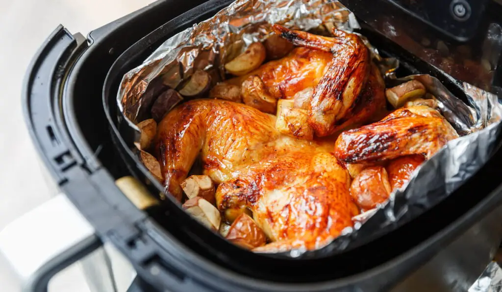 roasted chicken with potatoes in an air fryer